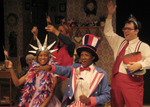 two actors dressed similar to the statue of liberty and uncle sam with another actor raising his arm in suspenders