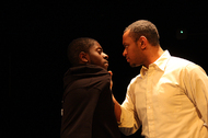 actor grabbing another actor in a black hoodie by the collar