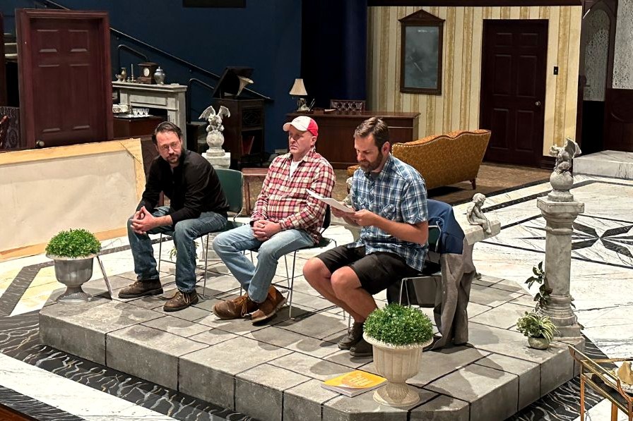 photo of three men on the stage of CLUE theatre production